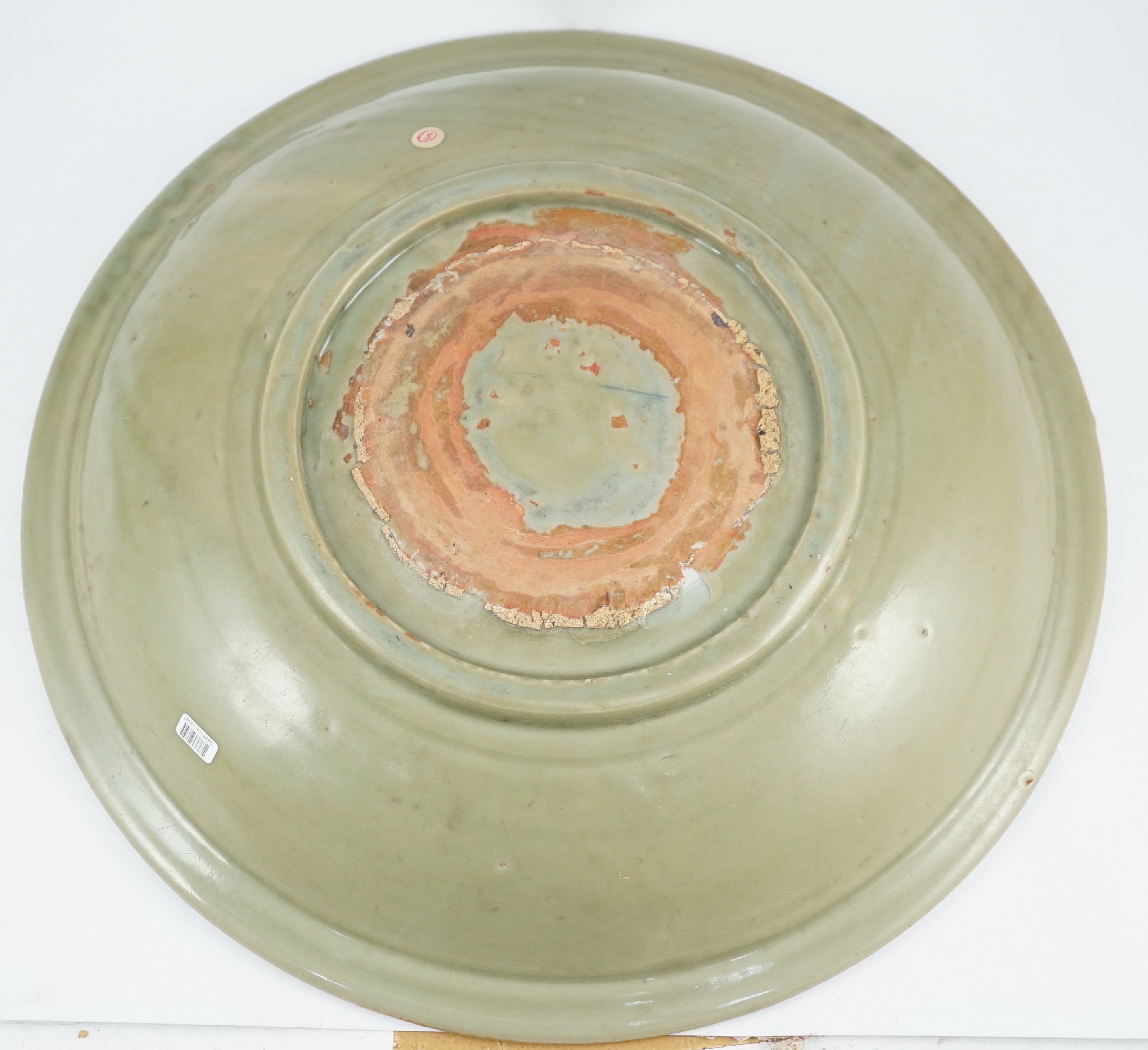 A Chinese Ming Longquan celadon ‘diaper and floral’ charger, 15th century, 45cm diameter, wear to glaze